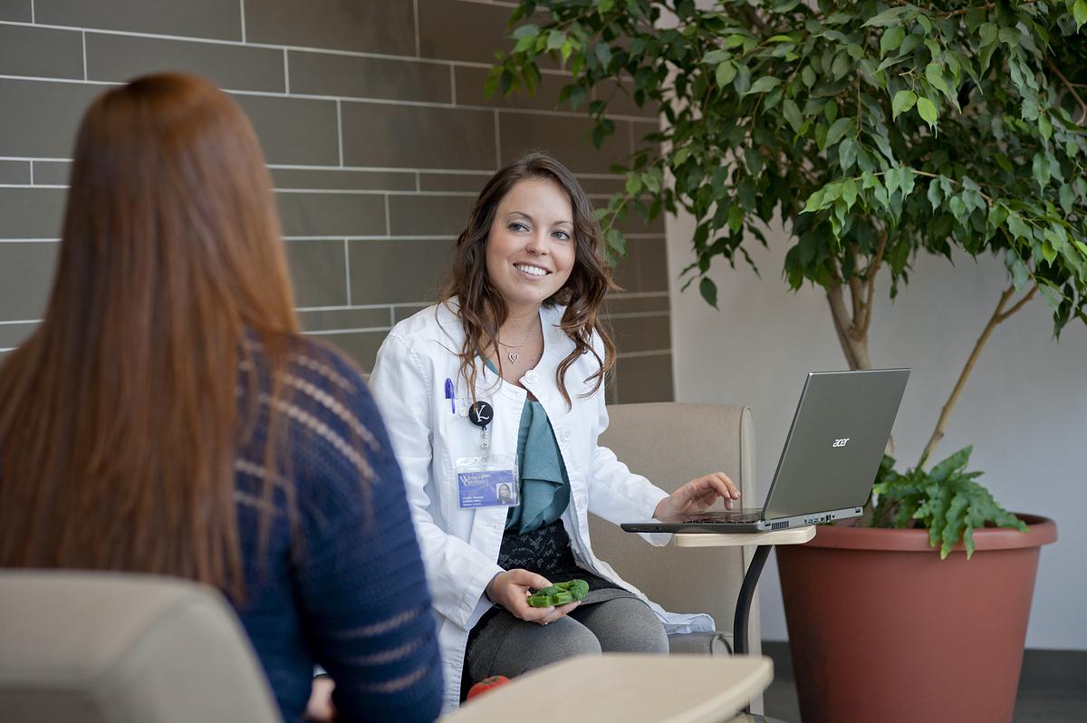 Nursing student talking with patient in a waiting room