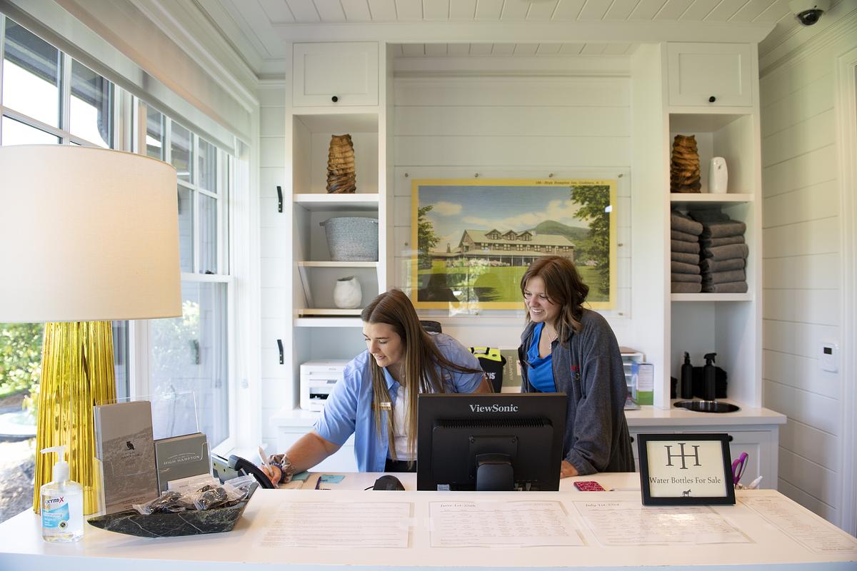 Student and teacher at a desk working on a task