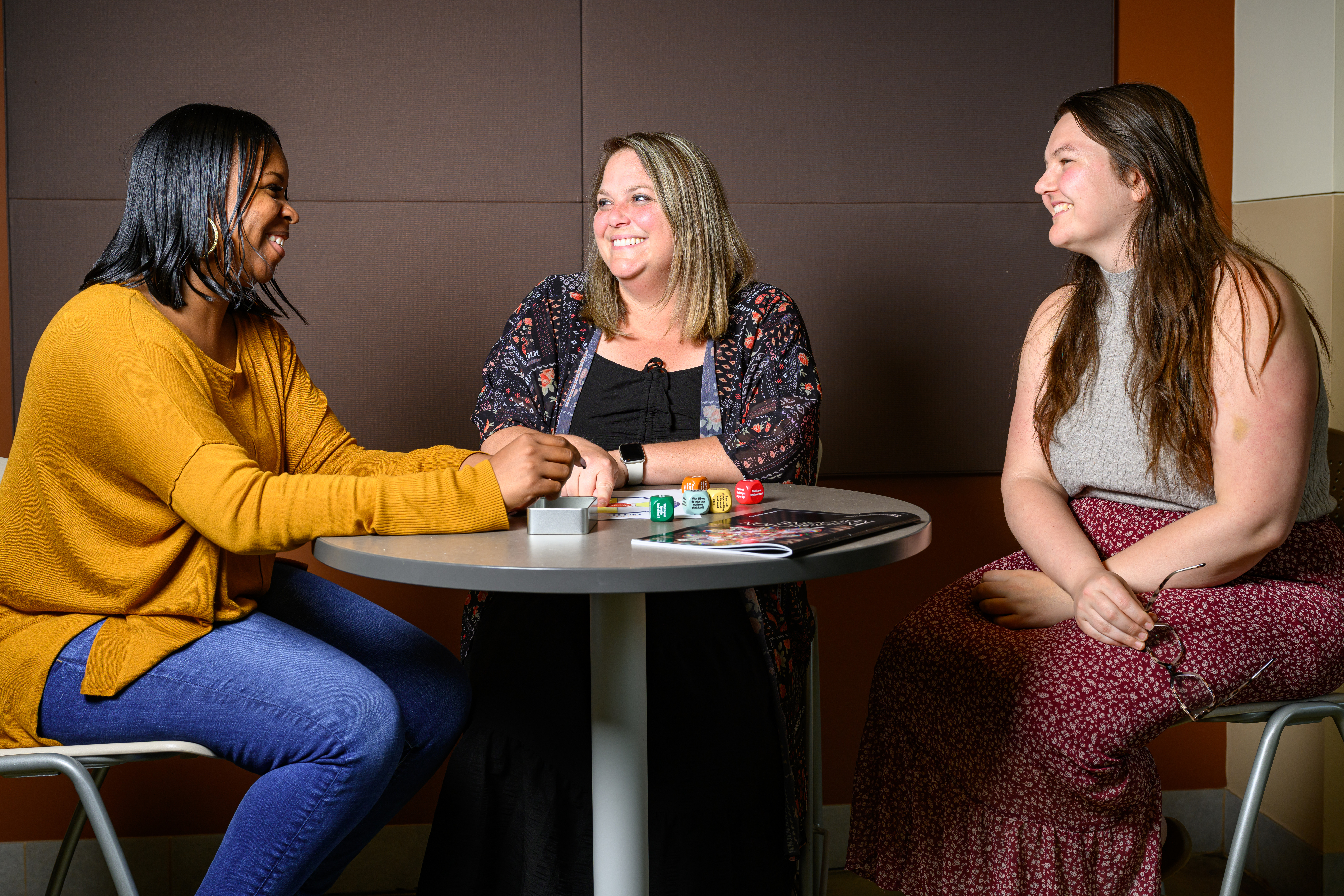Counseling students sitting around a table talking