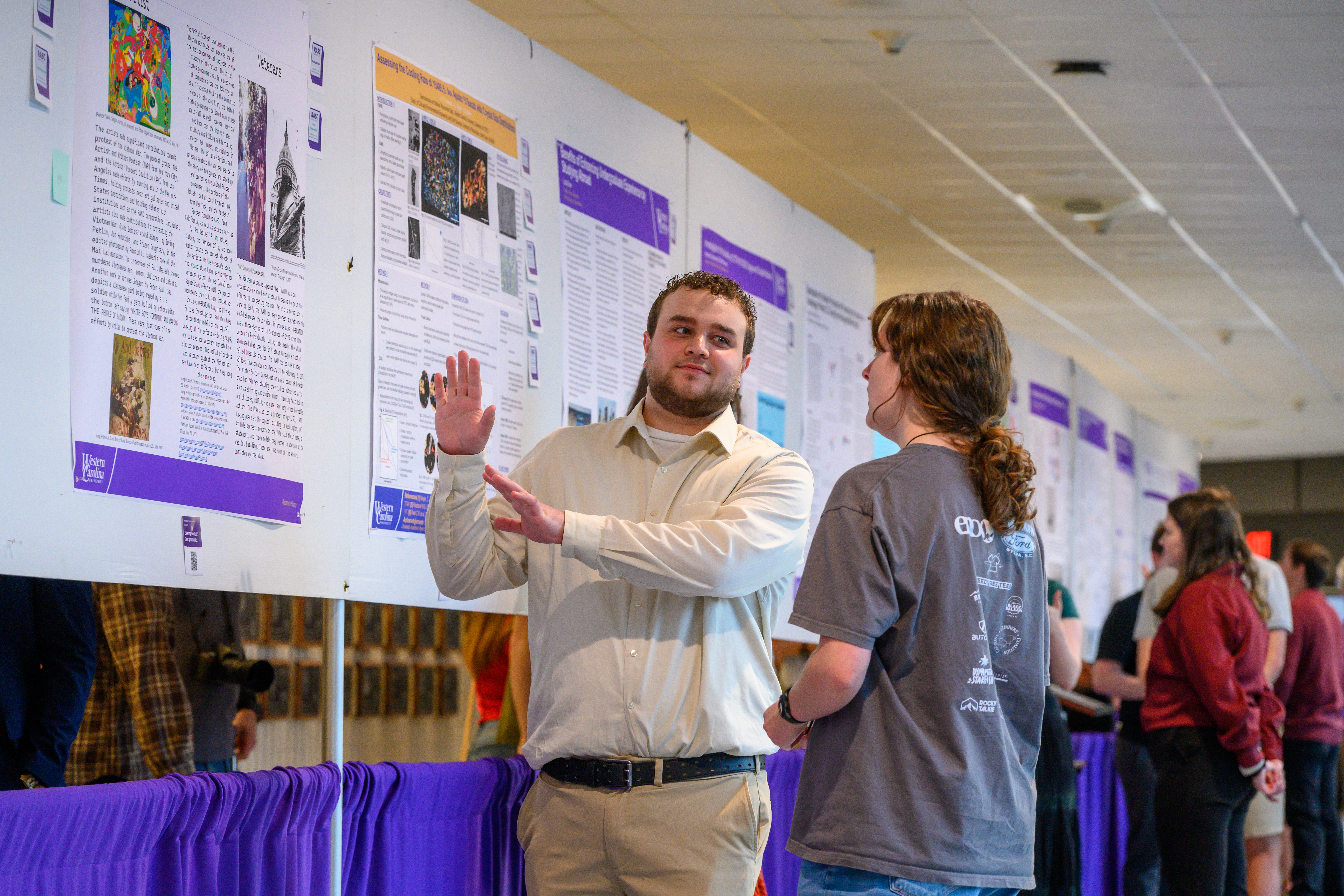 Ģ������Ƶstudent shows his poster during the poster presentation portion of RASC
