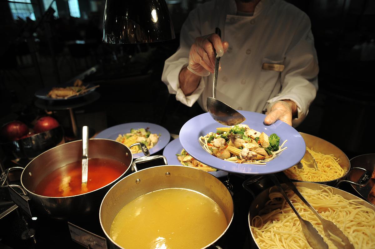 Chef serves up a plate of food for the camera