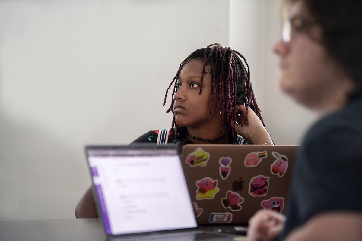 Two students pay close attention to a lecture in class