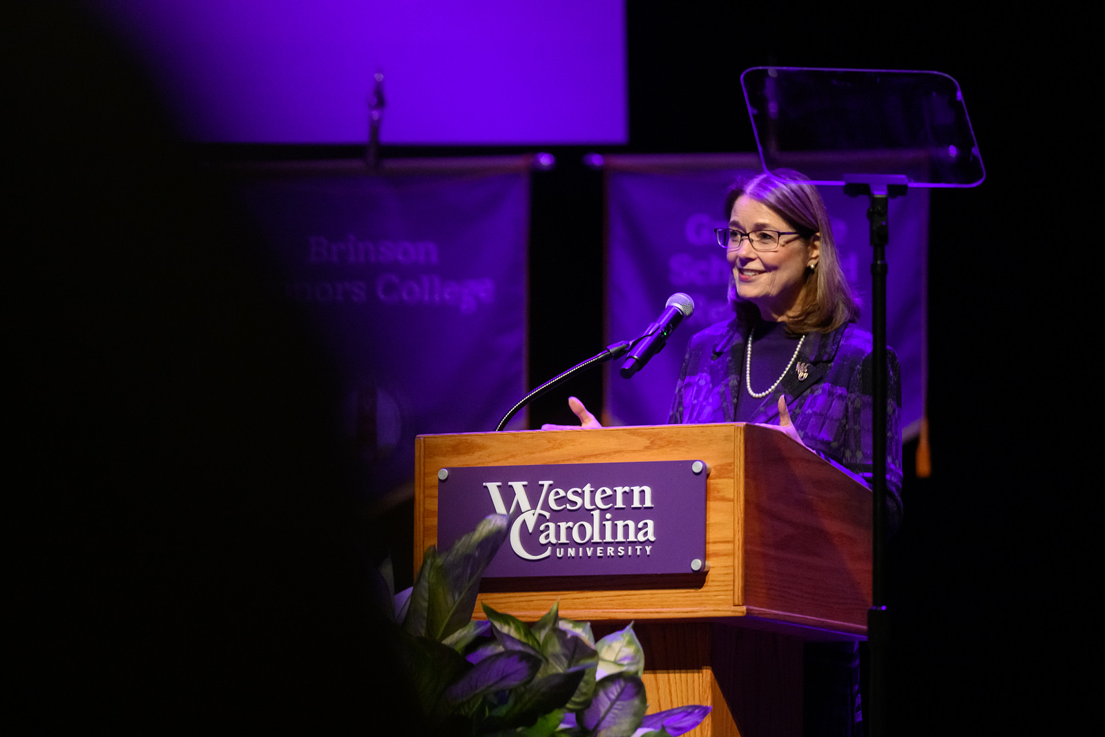 Chancellor Brown standing and smiling at a podium giving a speech