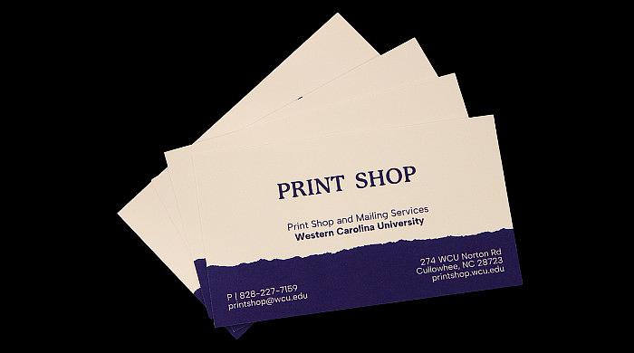 A variety of business cards and stationary laid out on a table