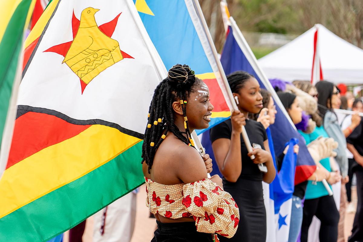 International festival participants holding flags together in celebration 