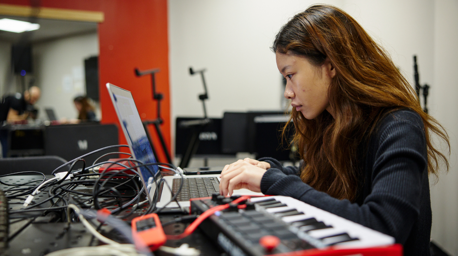 Student works on a laptop and keyboard